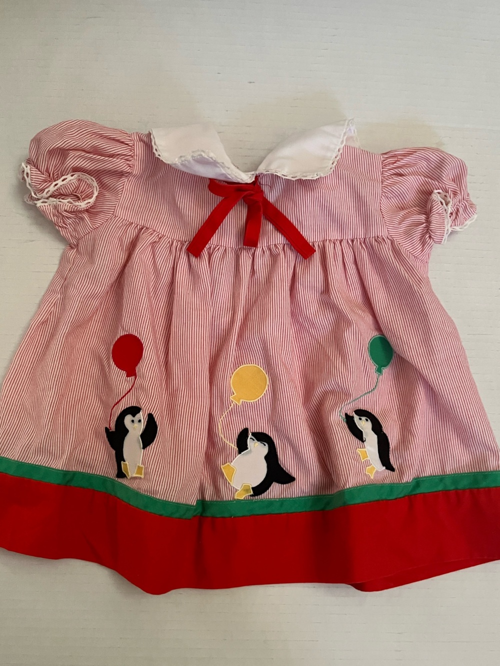 Nannette Red and white dress with penguins holding balloons
